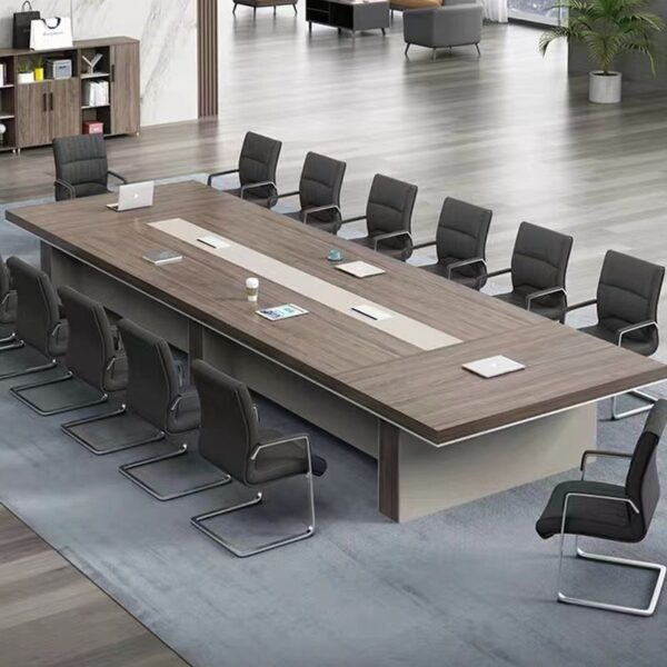 A large, elegant 14-16 seater boardroom table made of polished hardwood, featuring rounded edges and built-in cable management, set in a modern office space.