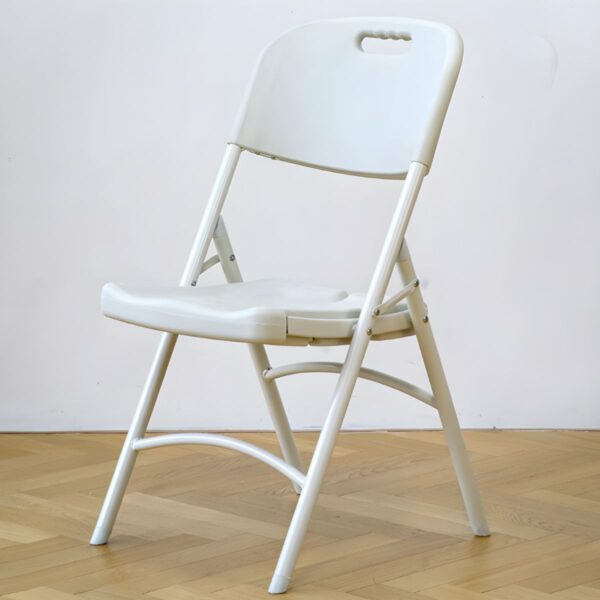 White foldable plastic chair set up in a bright outdoor setting, showcasing its sleek design and lightweight structure.