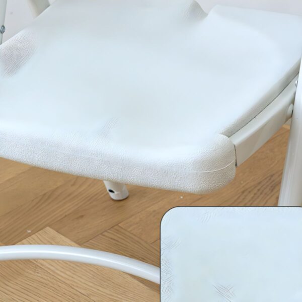 White foldable plastic chair set up in a bright outdoor setting, showcasing its sleek design and lightweight structure.