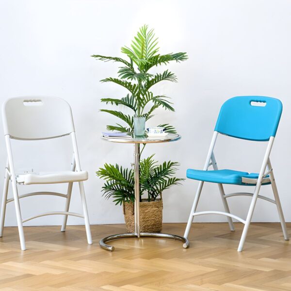 White foldable plastic chair set up in a bright outdoor setting, showcasing its sleek design and lightweight structure.