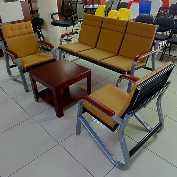 Elegant 5-seater brown reception sofa with plush cushions and wooden legs in a modern office setting.