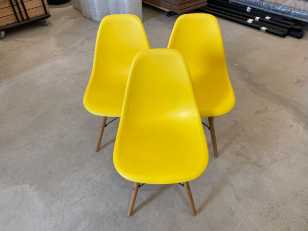 Eames Plastic Dining Seat with a sleek plastic shell and wooden legs, showcasing mid-century modern design.