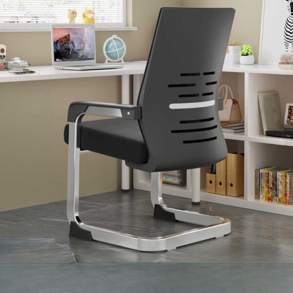 Black Office Mid-Back Guest Seat in a modern office setting, showcasing its sleek design and comfortable padding.