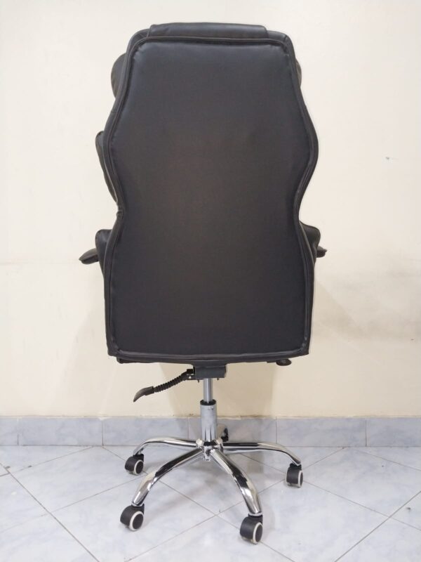 Black Directors Executive Office Chair with leather upholstery and chrome base in a modern office setting.