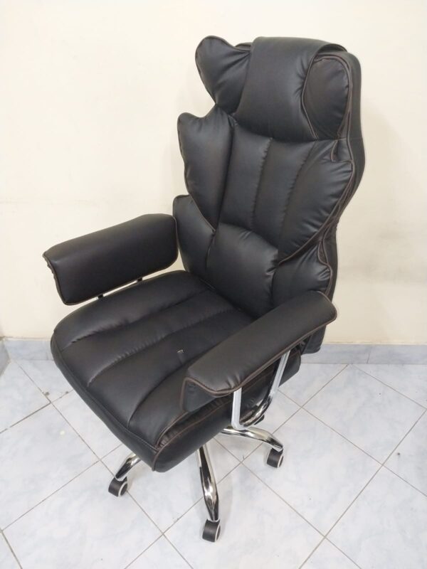 Black Directors Executive Office Chair with leather upholstery and chrome base in a modern office setting.