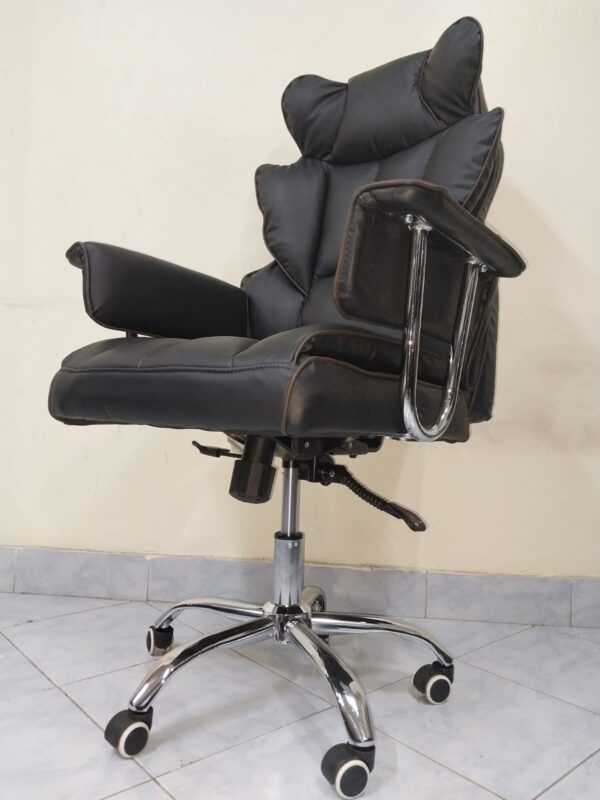 Black Directors Executive Office Chair with leather upholstery and chrome base in a modern office setting.