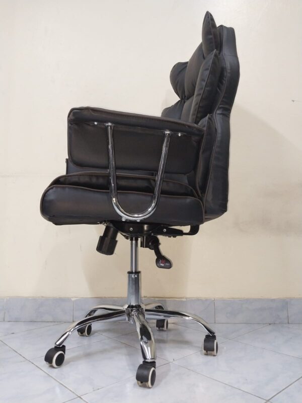 Black Directors Executive Office Chair with leather upholstery and chrome base in a modern office setting.