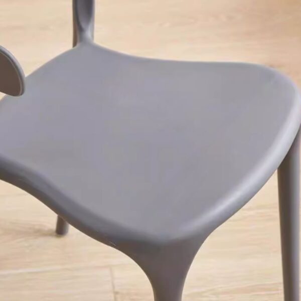 Bseak Plastic Dining Chair in a modern dining room setting, showcasing its sleek design and vibrant color options.