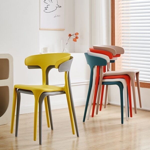 Bseak Plastic Dining Chair in a modern dining room setting, showcasing its sleek design and vibrant color options.