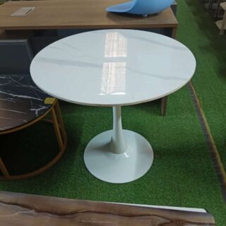 White Round Eames Dining Table with a glossy finish and sleek design, elegantly set in a modern dining area.