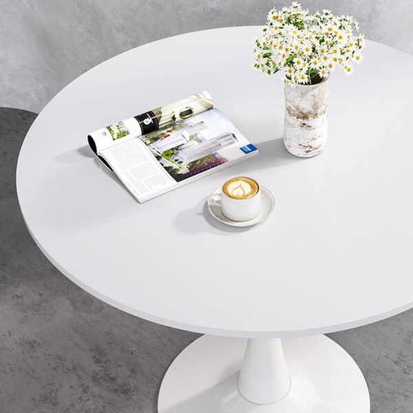 Round White Engineered Wood Dining Table with a smooth, sleek finish, ideal for modern dining rooms or kitchens.