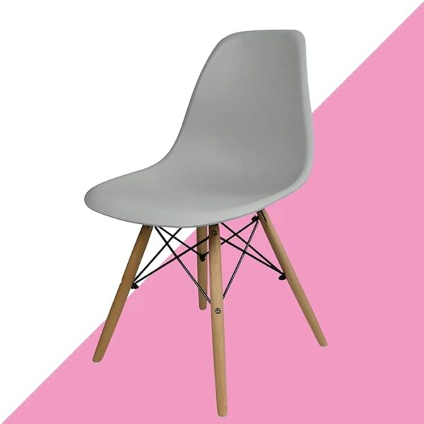 Eames Modern Plastic Dining Chair with molded plastic seat and wooden legs, set in a stylish dining room setting.