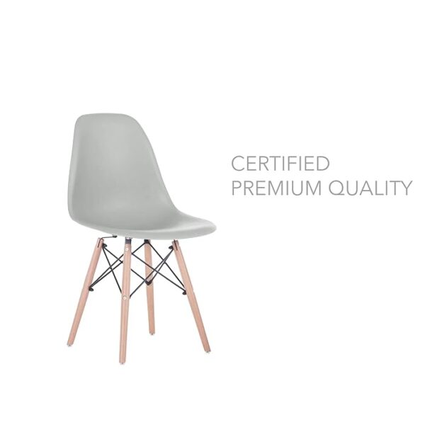 Eames Modern Plastic Dining Chair with molded plastic seat and wooden legs, set in a stylish dining room setting.