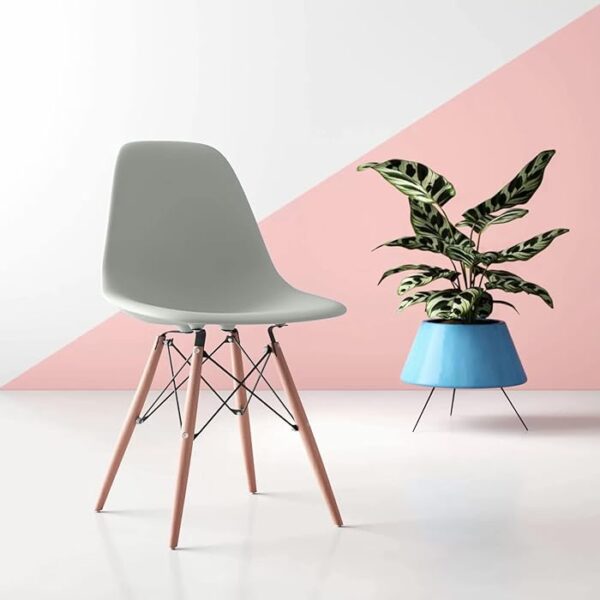 Eames Modern Plastic Dining Chair with molded plastic seat and wooden legs, set in a stylish dining room setting.