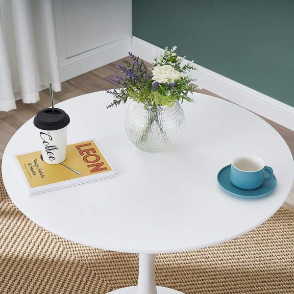 White modern round living room table with minimalist design and smooth surface.