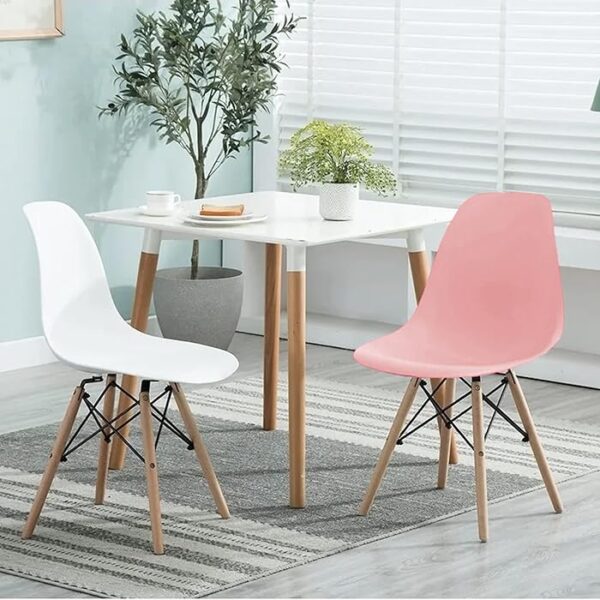 Modern Armless Eames Dining Chair with molded plastic seat and wooden dowel legs, offering a sleek and ergonomic design for contemporary dining spaces.