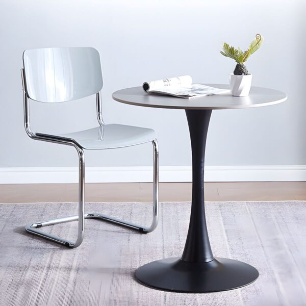 The Round Tulip Home Office Dinner Table features a sleek white tabletop and a unique tulip-shaped base. Ideal for dining or working, it adds modern elegance to any home or office space.